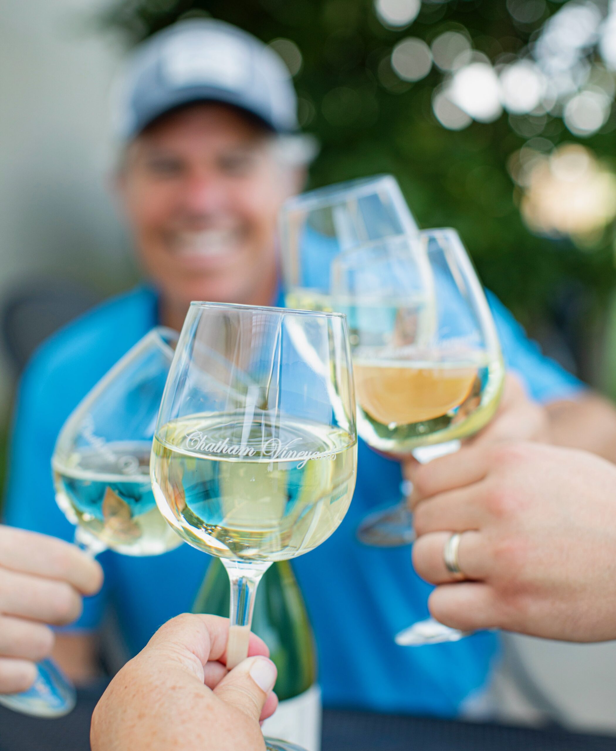 Group of wine glasses making a toast at Chatham Vineyards