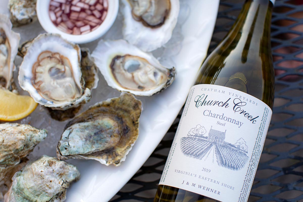 Shucked oysters and a bottle of Chardonnay at Chatham Vineyards