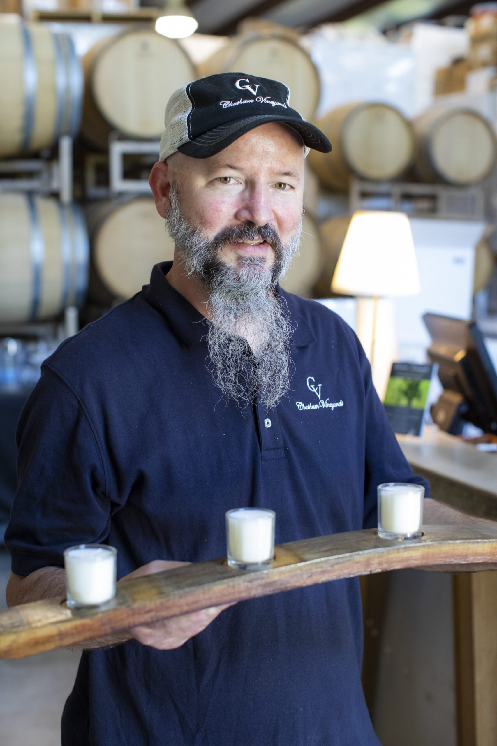 Ethan Watkins holding a barrel stave he repurposed into a candle holder