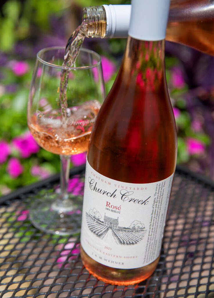 Bottle of Chatham Vineyards Rose next to a glass of rose being poured