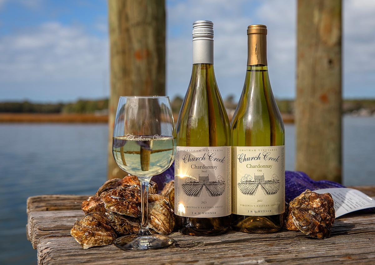 Chatham Vineyards Steel Chardonnay and 2022 Oak Chardonnay on pier with oysters