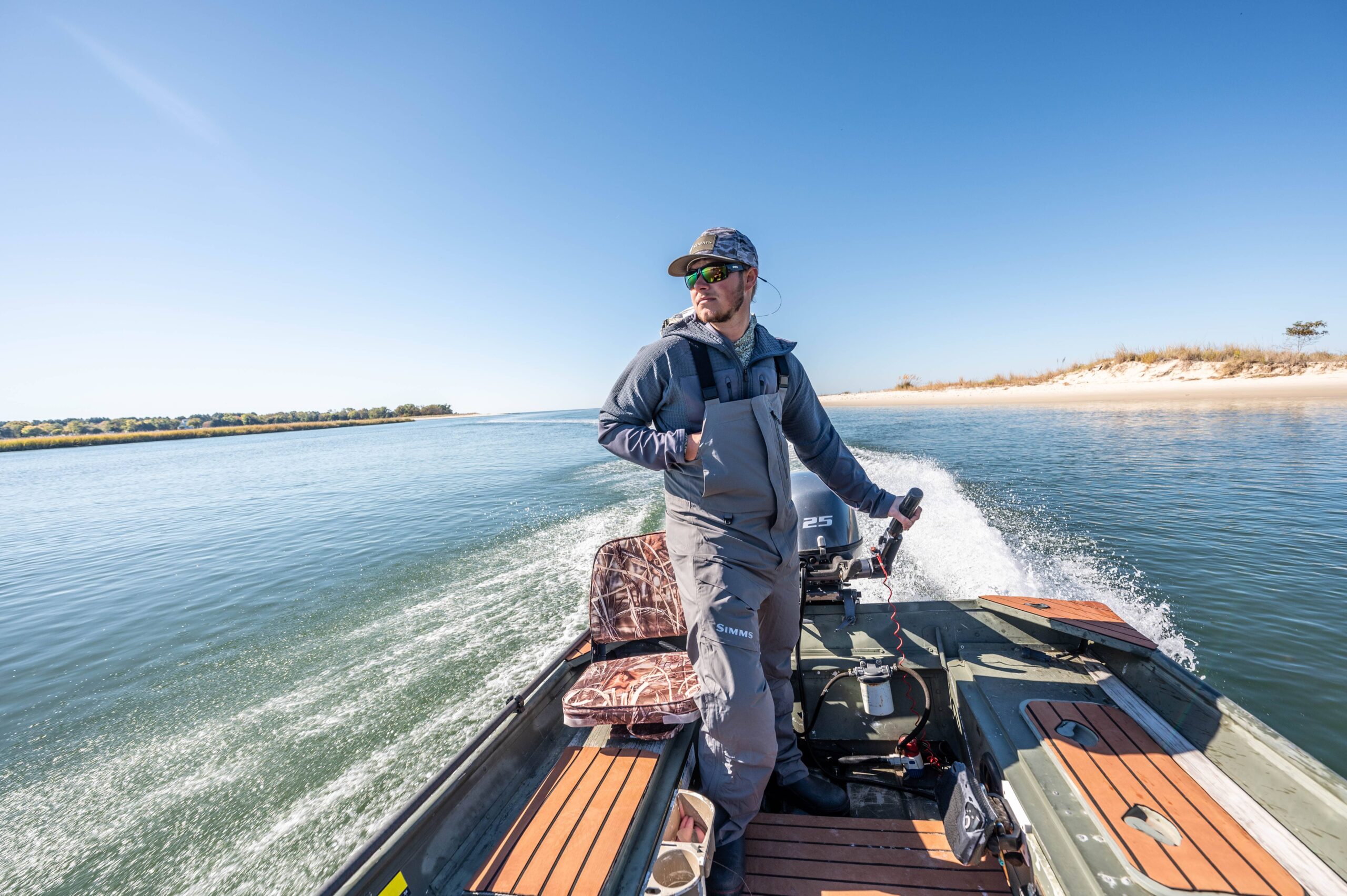 Jon Wehner driving a fishing boat along the water